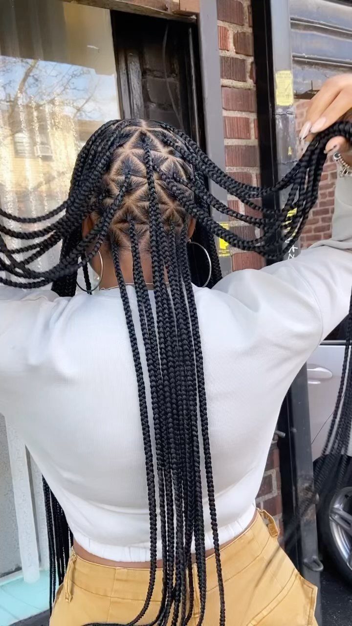 Black hair styled in cornrows braided to the scalp with long loose braids.