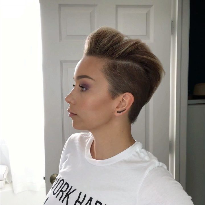 Woman with a light brown textured faux hawk and shaved sides in profile.