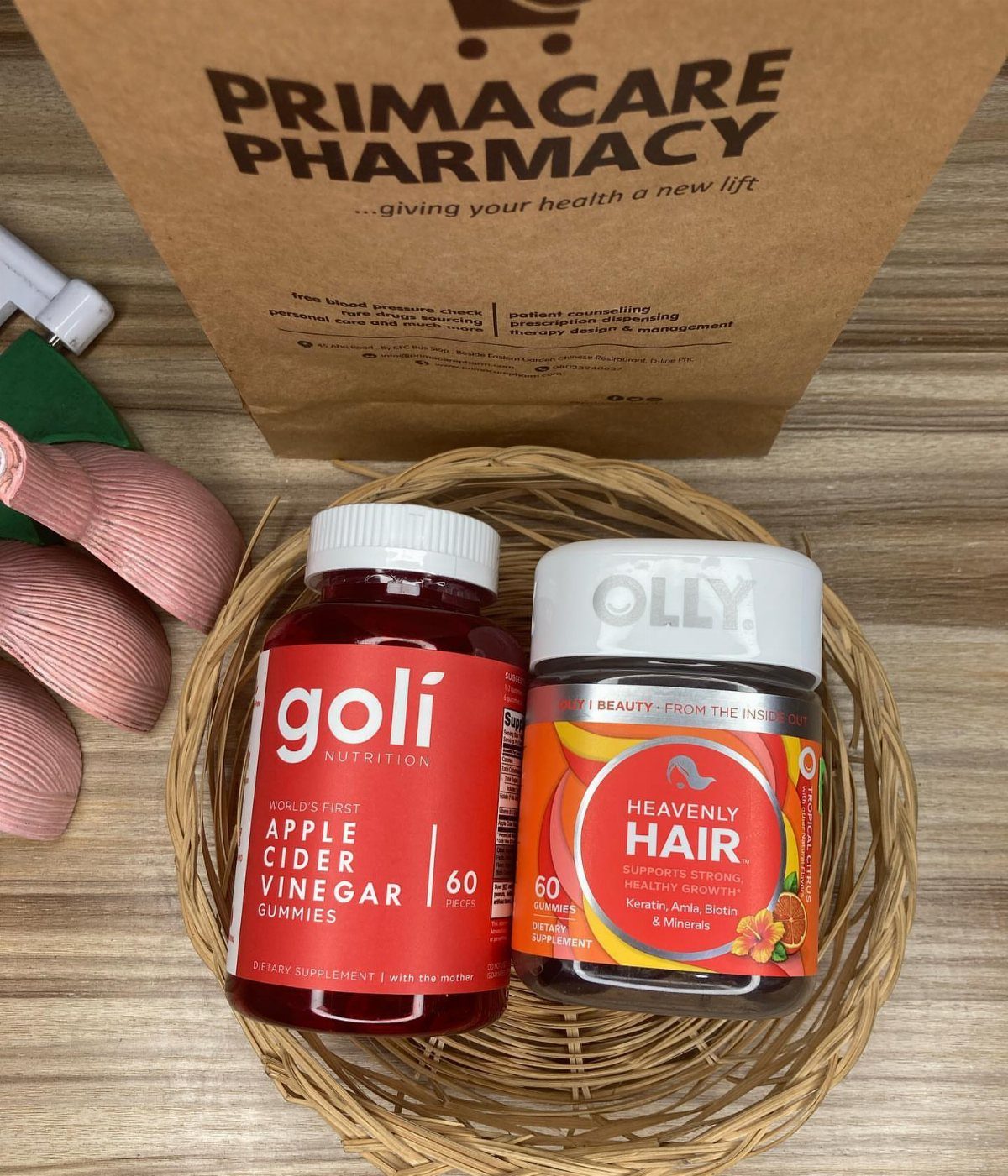 OLLY Heavenly Hair gummies and Goli ACV gummies in a woven basket.