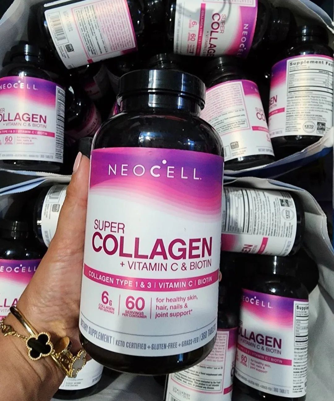NeoCell Super Collagen supplement bottle held by a hand with gold jewelry