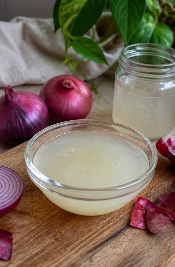 Cut onion and a small bowl of freshly extracted onion juice