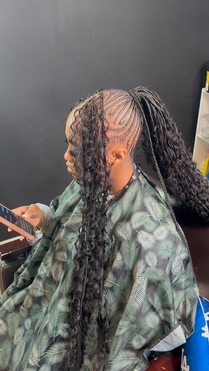 High braided ponytail with curly ends and scalp braids on a person.