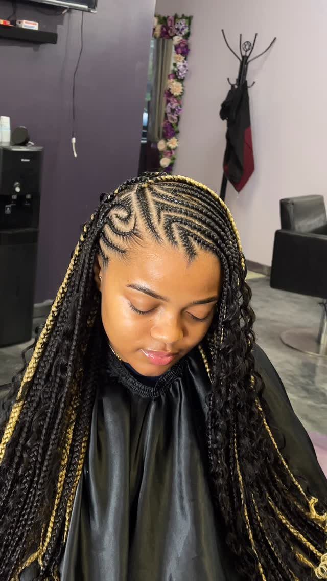 Woman with curved cornrows on scalp and long braids with gold highlights.